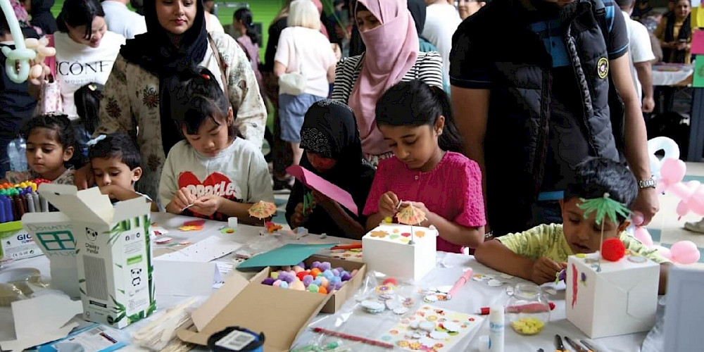 Children participate in a hands-on crafting activity at Rochdale Science Extravaganza